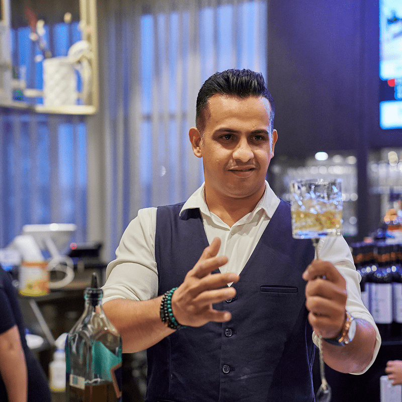 Professional bartender presenting a beverage