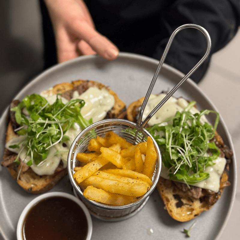 Open-faced sandwich with cheese and greens