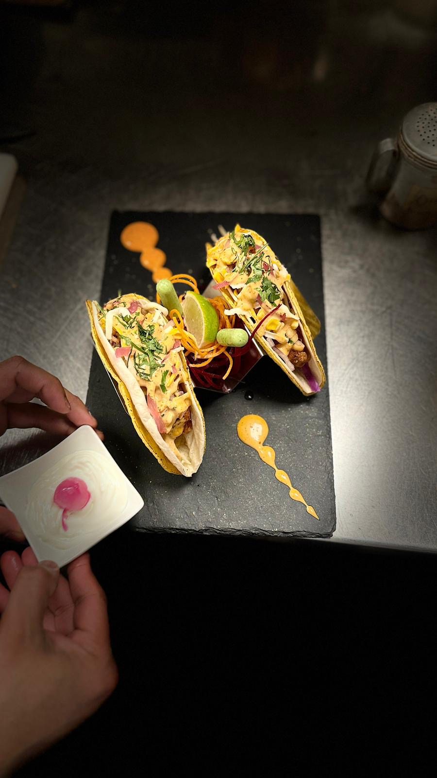 Colorful tacos with sauce drizzle