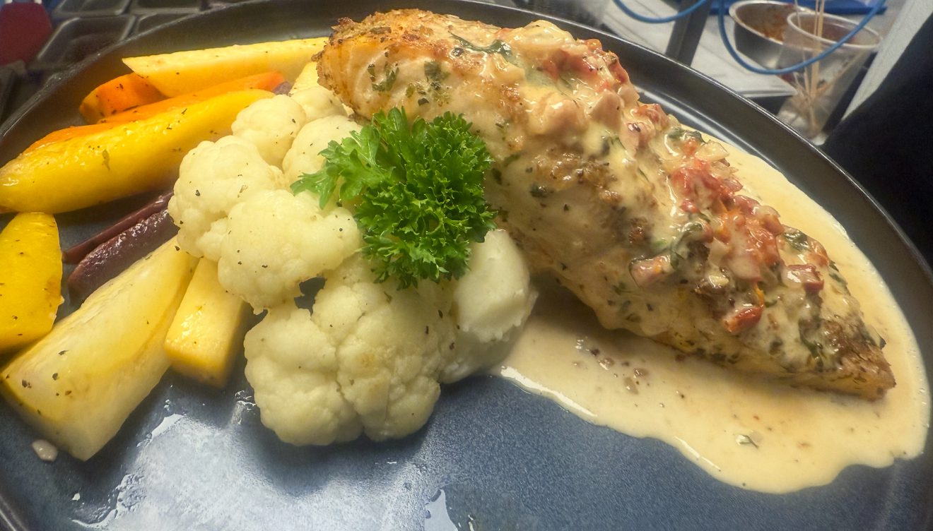 Roasted chicken breast on dark plate