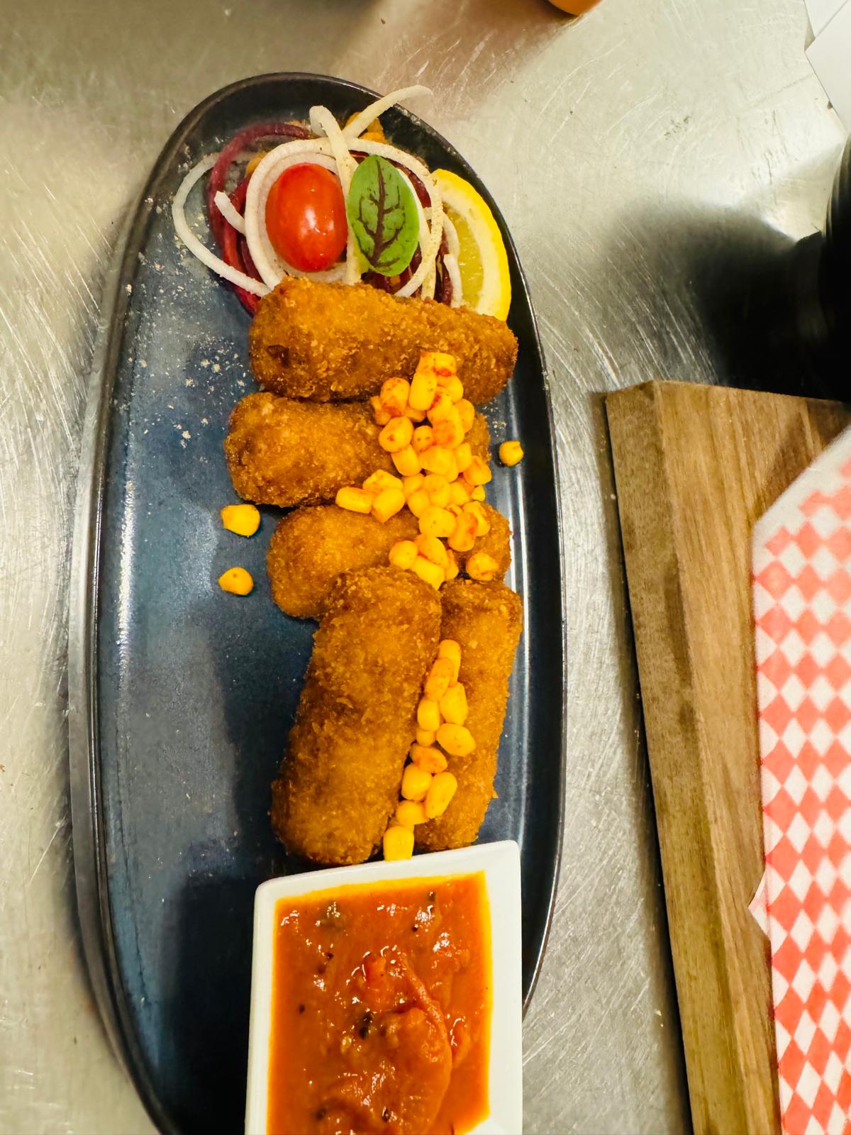 Appetizing croquettes on dark plate