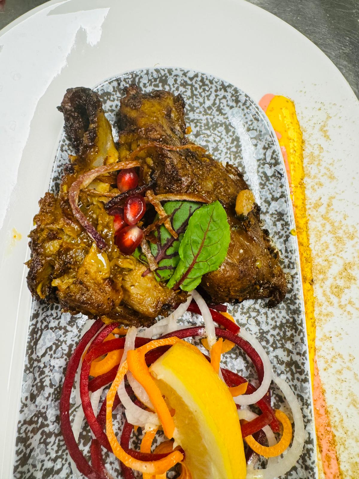 Grilled chicken with pomegranate garnish