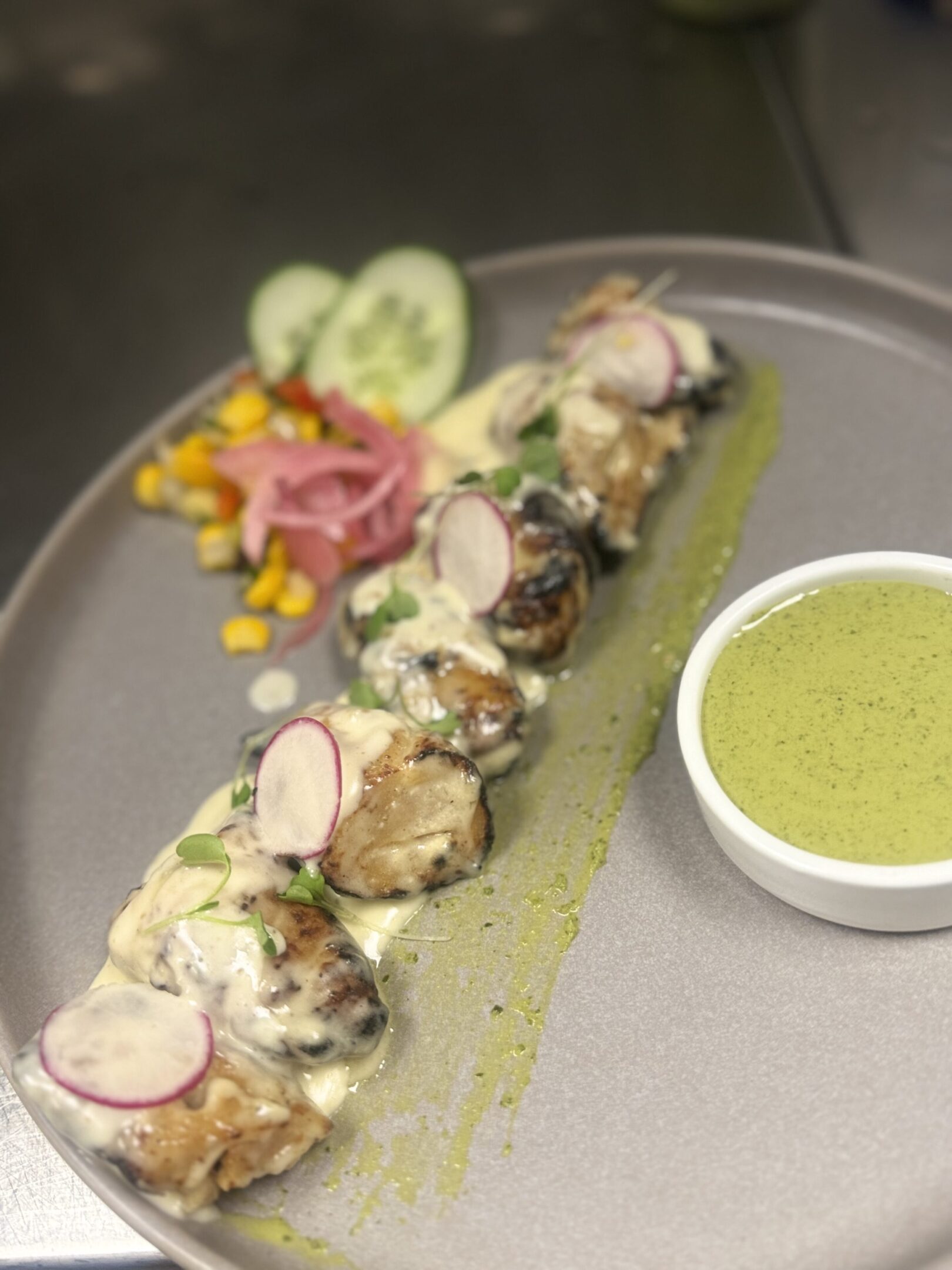 Plated dish with green sauce