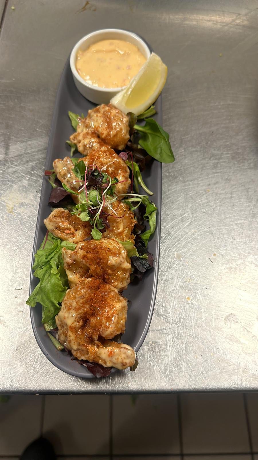 Seafood dish served with lemon wedge